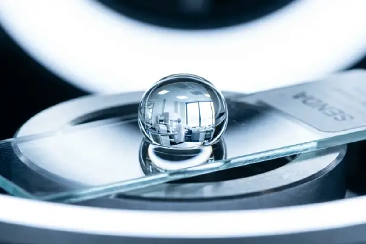 Water droplet on a lab surface representing paper straw adhesive purity screening.
