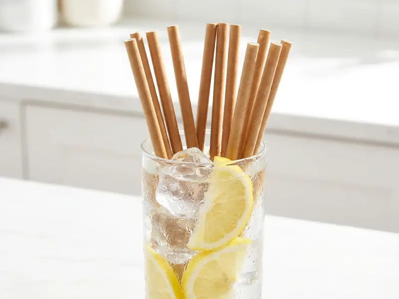Paper straws immersed in iced drink for cold-service water resistance testing.