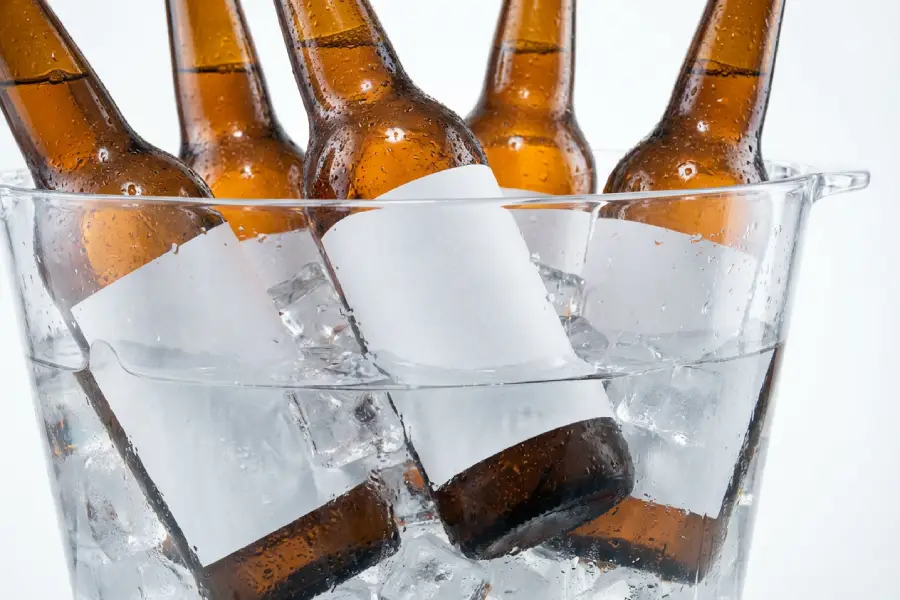 Ice-bucket submersion test on labeled glass bottles for beverage labeling adhesive qualification.