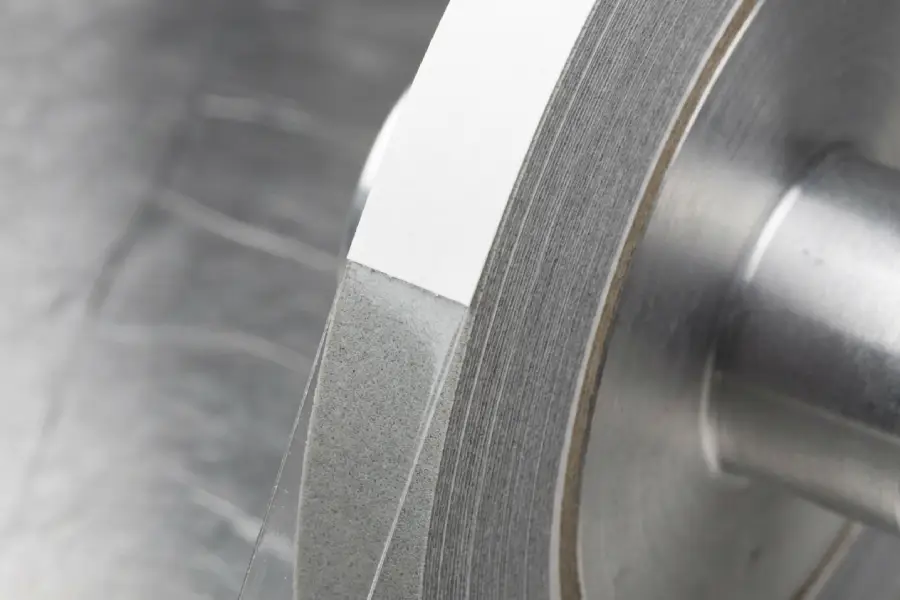 Industrial specialty tape roll showing clean die-cut edges after PSA qualification.